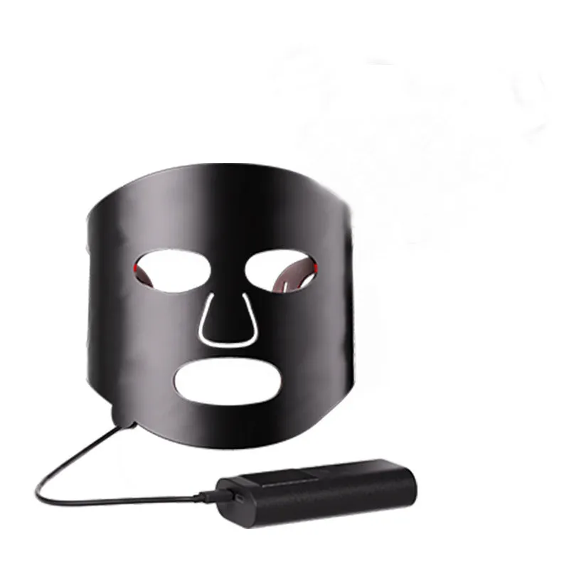 Black and gold LED phototherapy face mask with controller on a white background.
