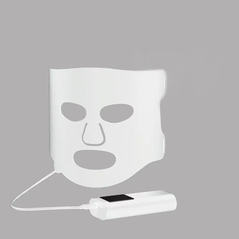 Black and gold LED phototherapy face mask with controller on a white background.