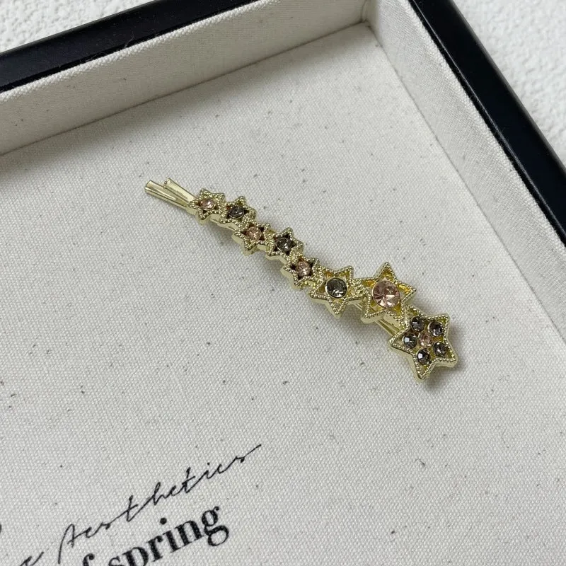 Gold-coloured alloy hair barrette with rhinestone, star, and word decoration in Korean style.