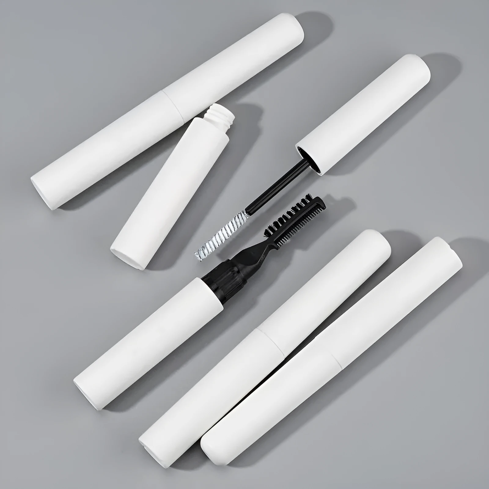 Pink and white eyebrow glue tube with applicator brush for natural wild brow styling.
