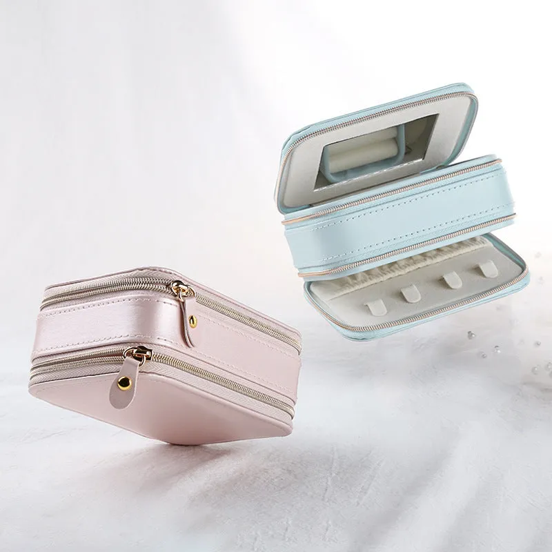 Small PU zipper jewellery box in light blue with fabric lining, 11.5x8.5x5cm, open to show rings and earrings