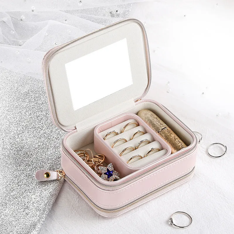 Small PU zipper jewellery box in light blue with fabric lining, 11.5x8.5x5cm, open to show rings and earrings