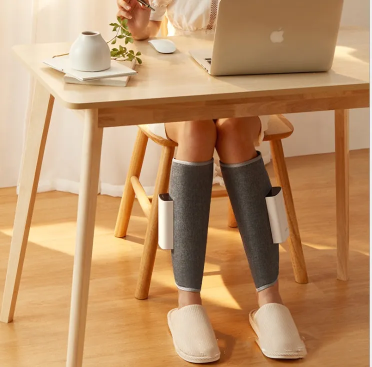 Rechargeable calf air wave leg massager with wireless remote control on a sofa