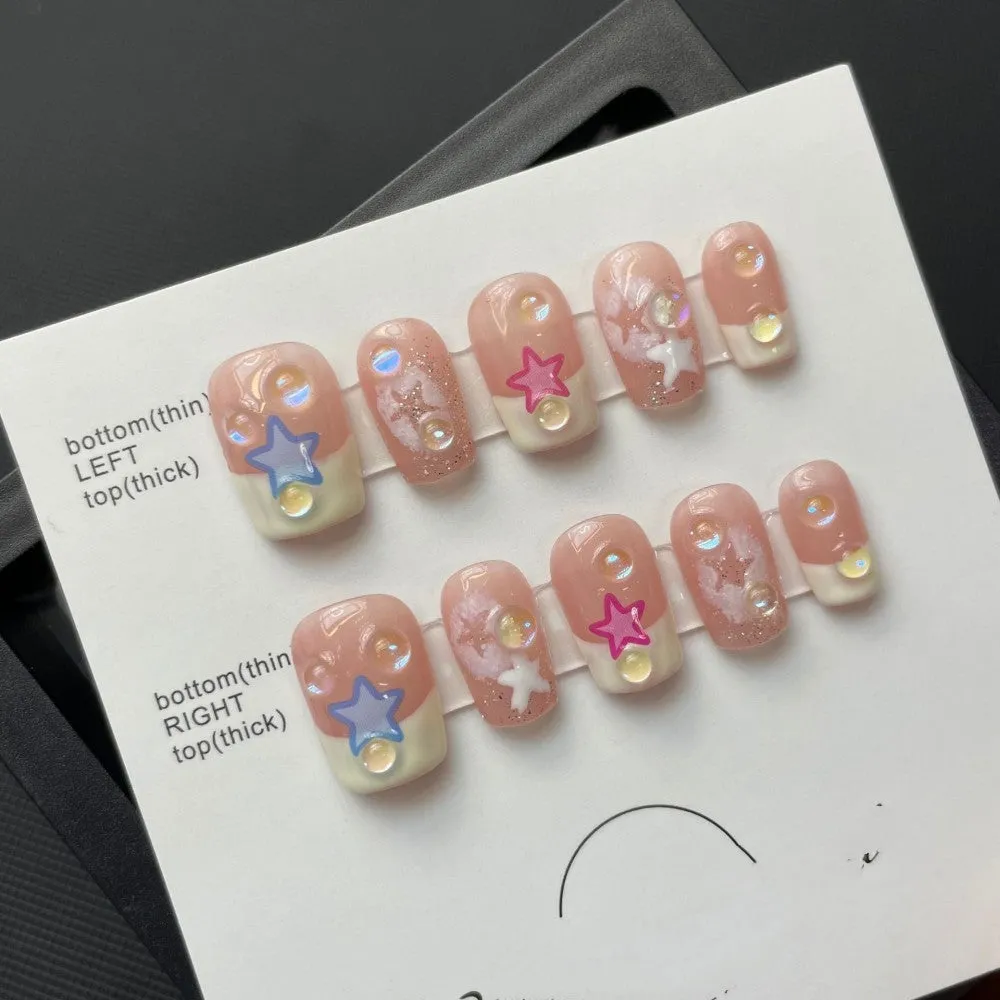 Handmade Sweet Star ladder pattern press-on nails in ultra-thin seamless style on a flat surface with glue and nail file