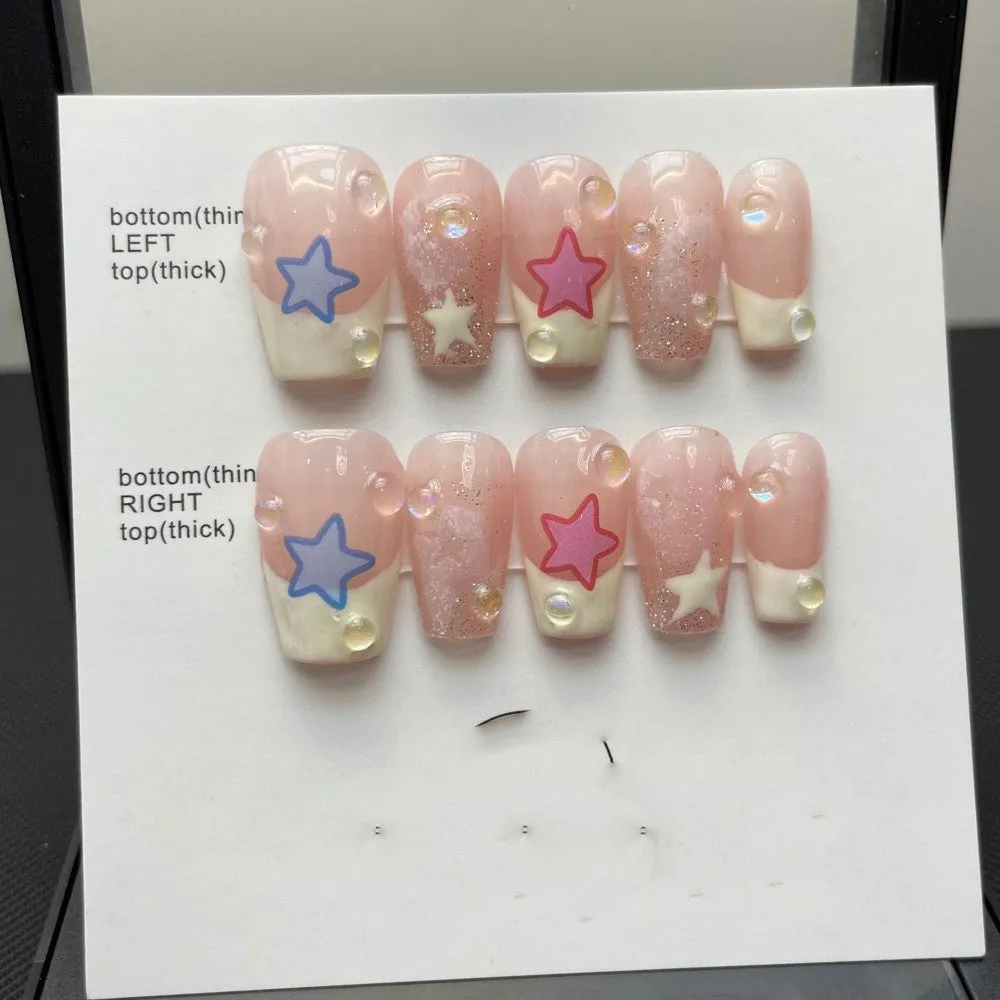 Handmade Sweet Star ladder pattern press-on nails in ultra-thin seamless style on a flat surface with glue and nail file