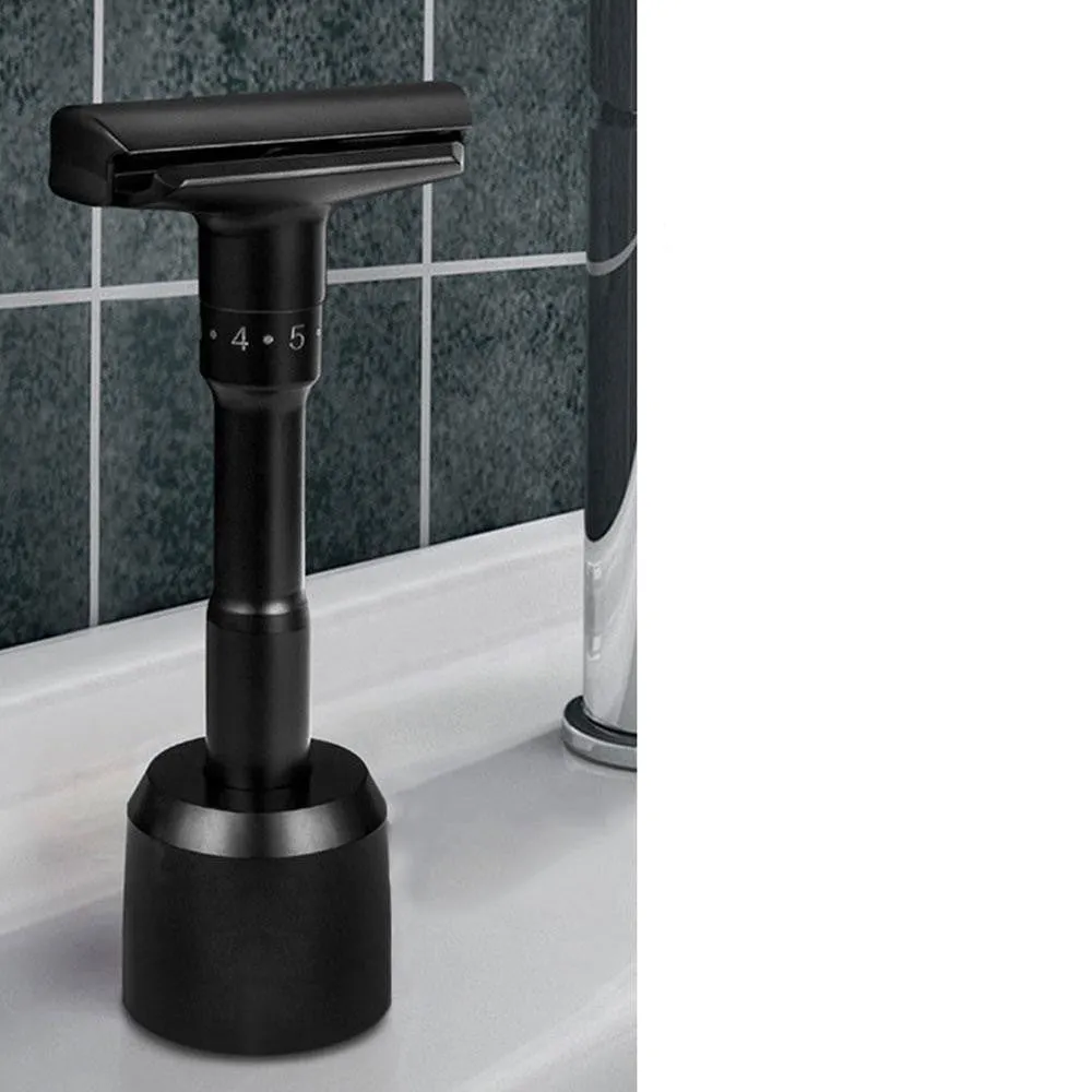 Manual old-fashioned razor with stainless steel blade and zinc alloy handle in black finish on a neutral background