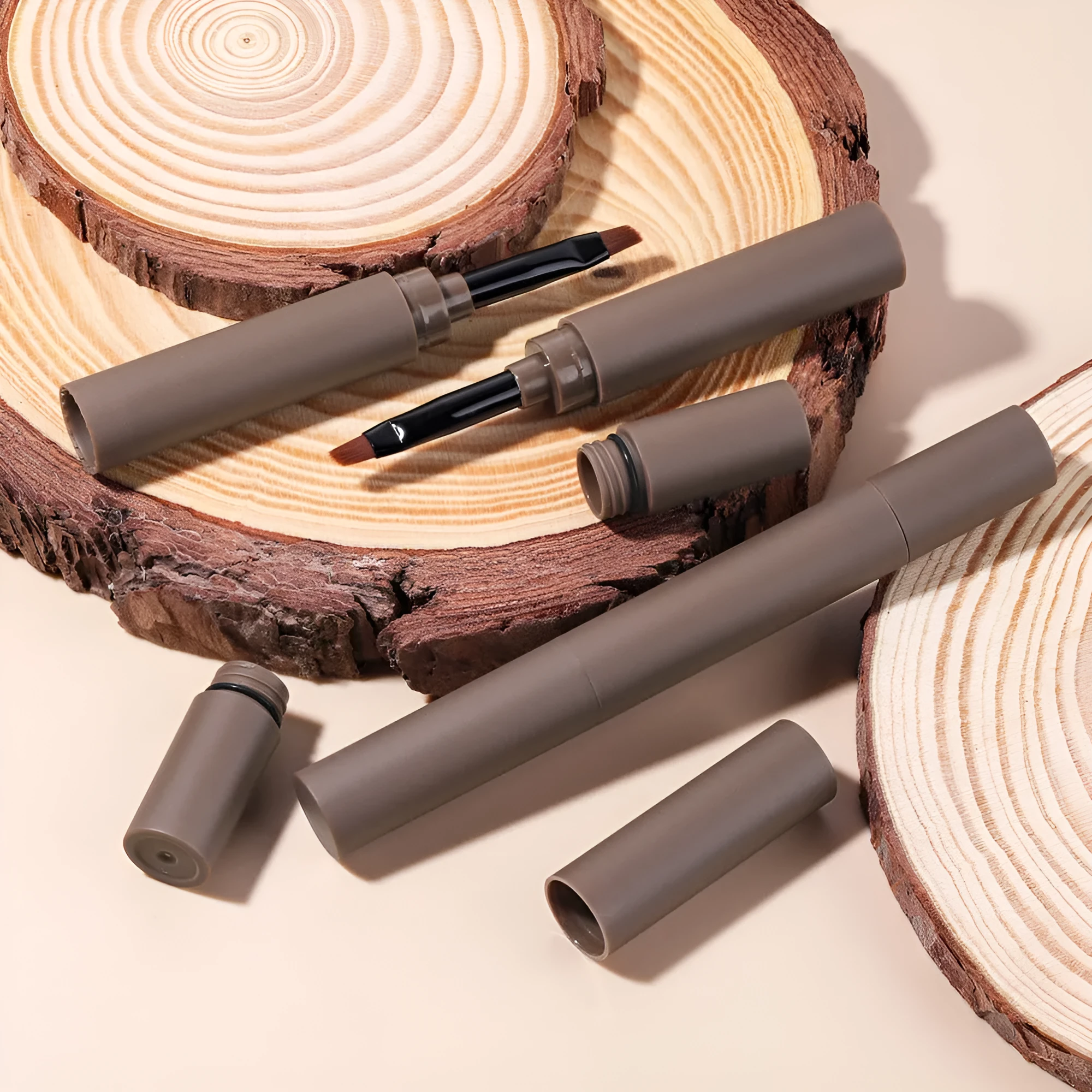 Double-headed eyebrow cream makeup pencil showing reddish brown, brown, light brown, dark brown, and black shades.