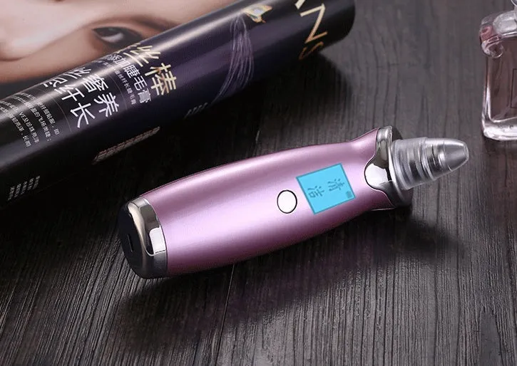 Blackhead remover pore cleaner with LCD display in ivory white on a clean surface