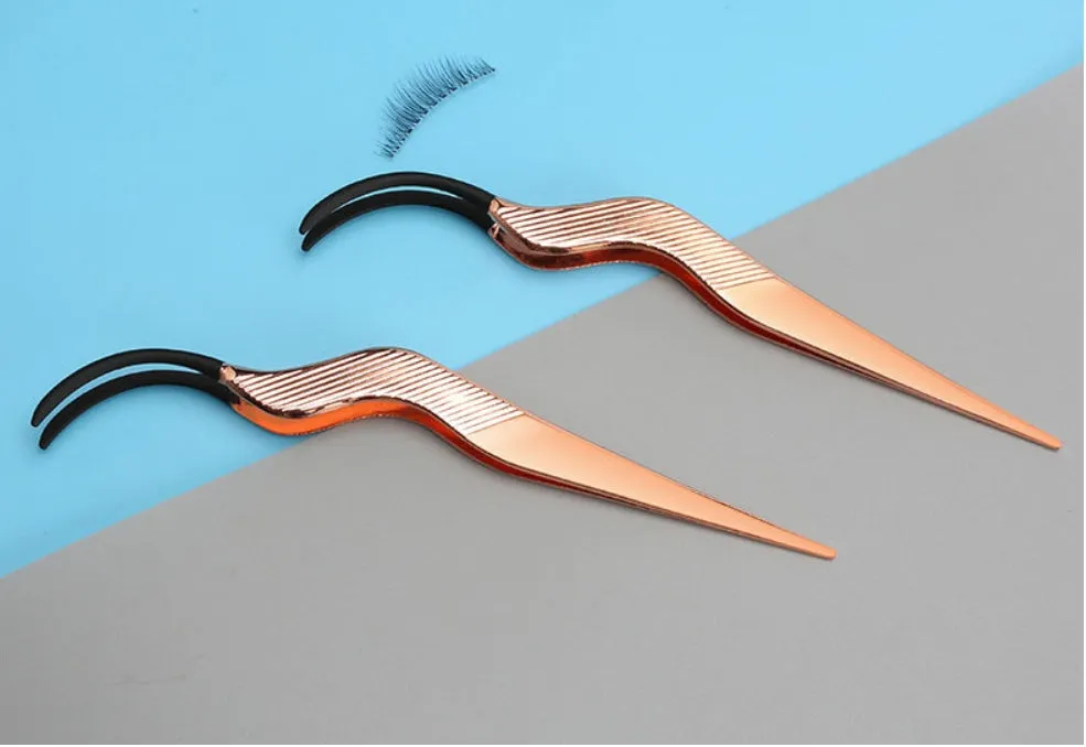 Rose gold metal false eyelash curler aid tool on plain background