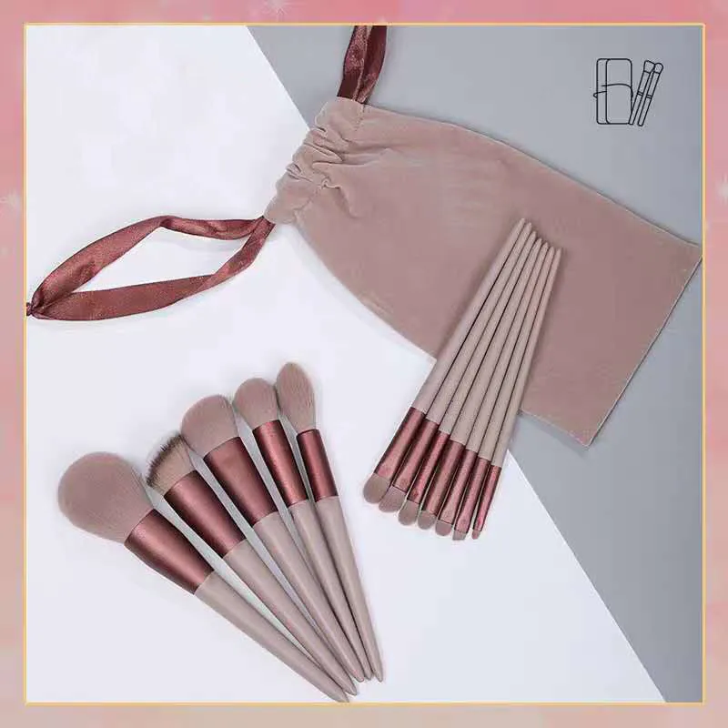 Thirteen Morandi green makeup brushes laid out, including blush and powder brushes