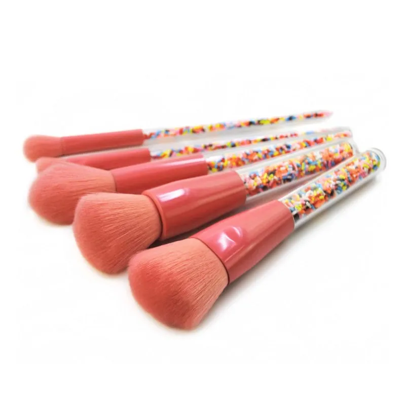 5 candy makeup brushes with colourful acrylic handles, fibre hair bristles, and aluminium ferrules on a white background