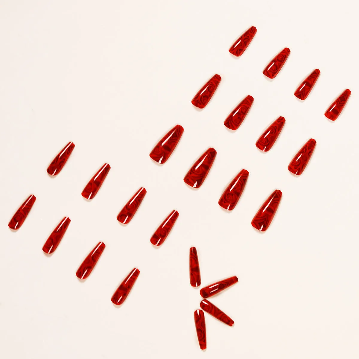 Hot wine red rose wearing nail art finished product set with 24 tablets and glue on white background