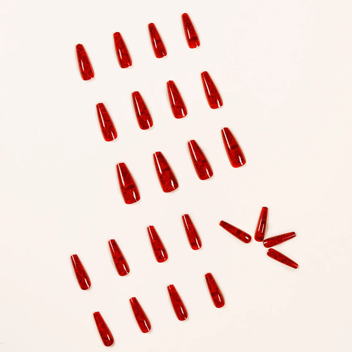 Hot wine red rose wearing nail art finished product set with 24 tablets and glue on white background