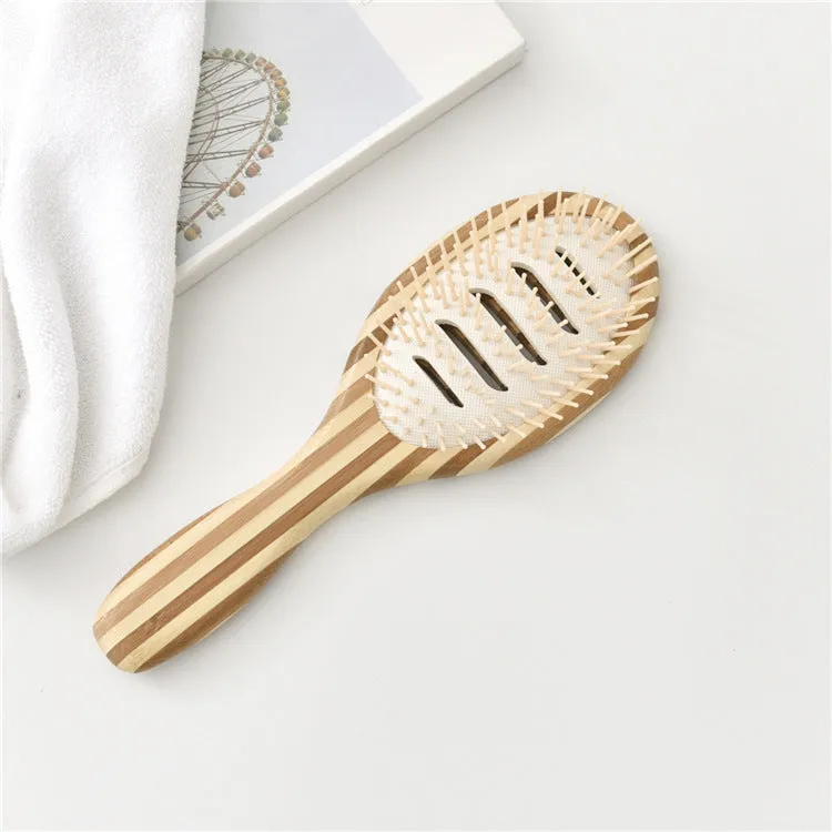 Natural bamboo scalp massage comb with round nylon teeth and rubber pad on neutral background