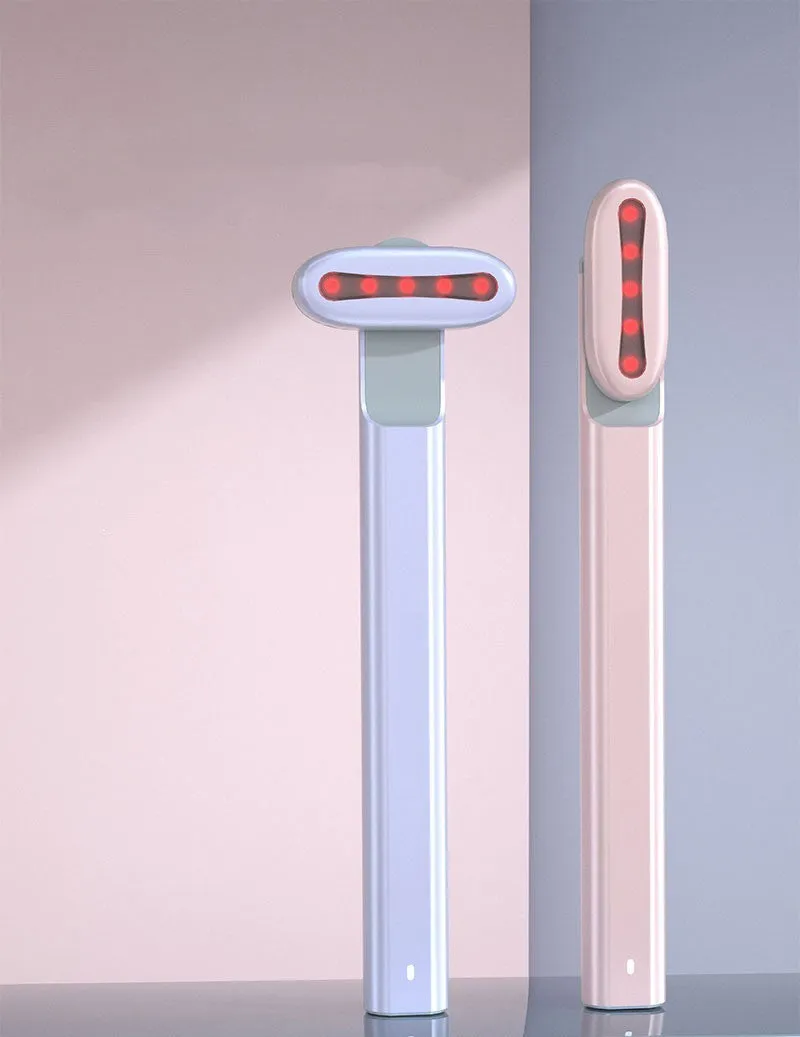 Micro current introduction eye massage instrument in green, with RF gear and USB charging cable on a white background