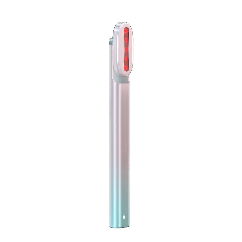 Micro current introduction eye massage instrument in green, with RF gear and USB charging cable on a white background