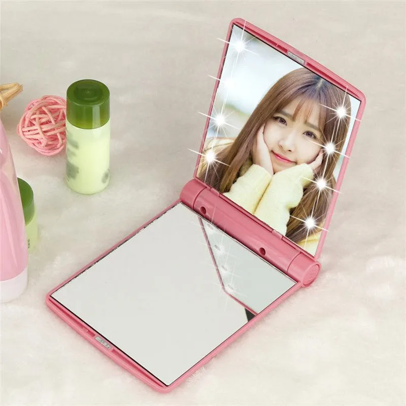 Folding LED pocket cosmetic mirror in Black, closed and open to show LEDs and compact size