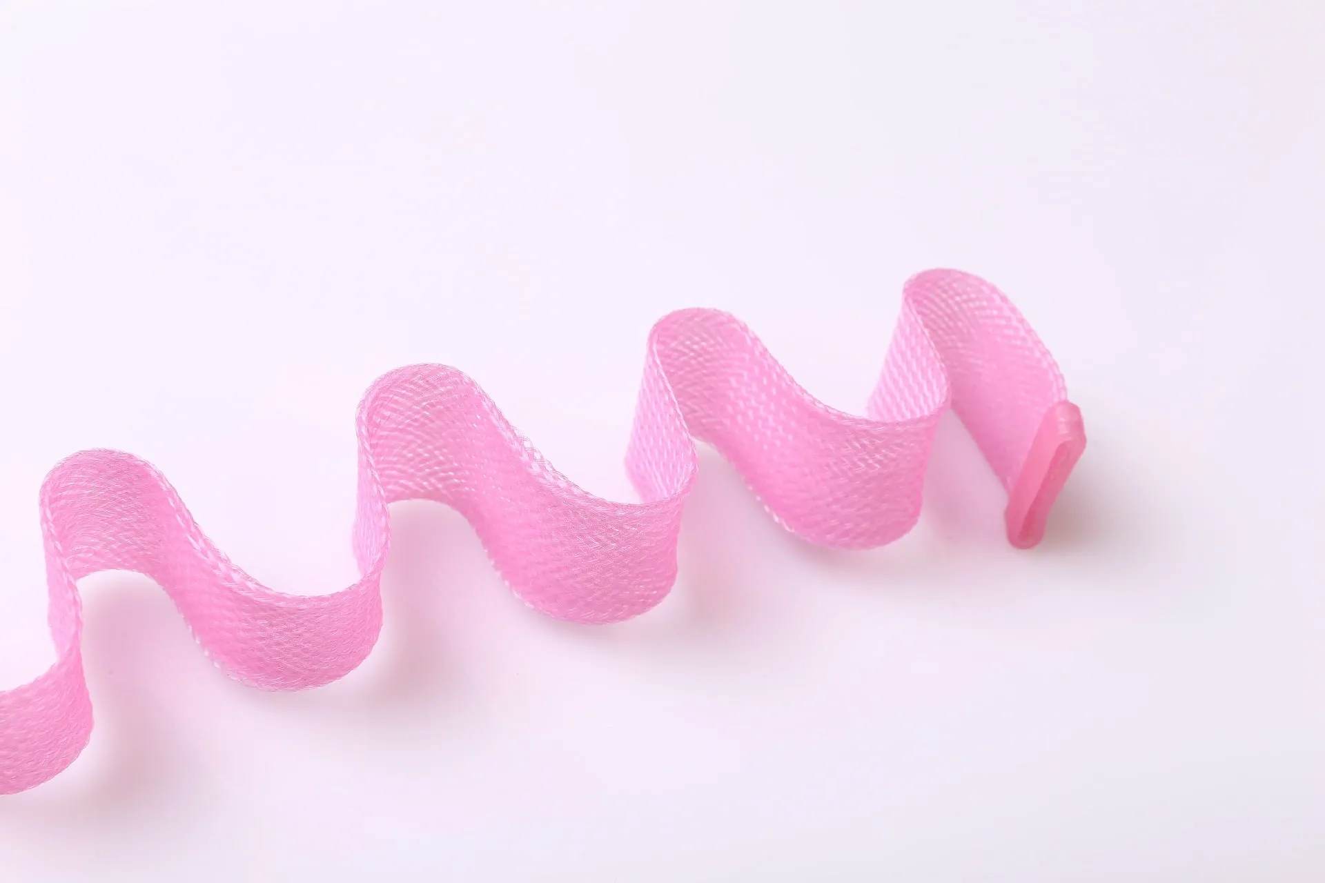 Twelve manual hair curlers in blue orange on a flat surface, 30cm length per curler