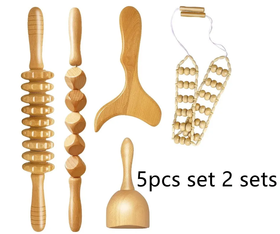 Set of three birch wood anti-cellulite massage hand rollers on a white background
