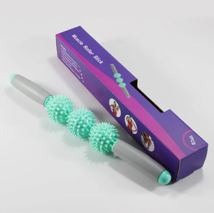 Anti cellulite massager stick with hedgehog-shaped balls and green padded ergonomic handles on a white background