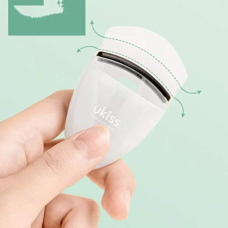 Mini portable eyelash curler in white with silicone pad and stainless steel arm