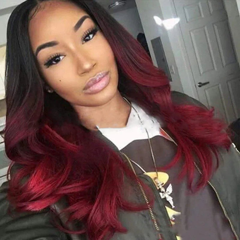 Burgundy long curly wig with gradient colour and centre bangs on a wig stand