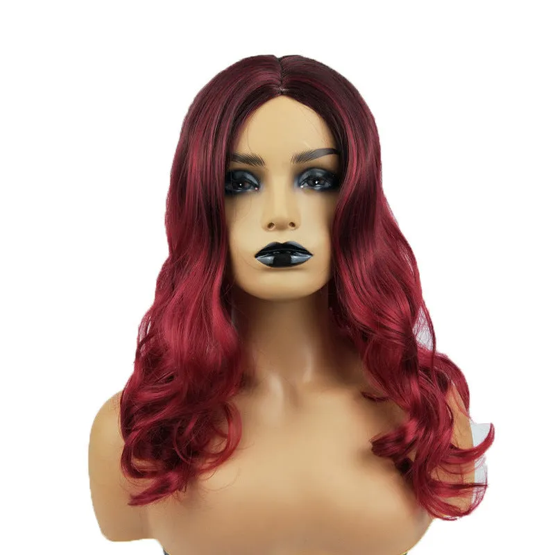 Burgundy long curly wig with gradient colour and centre bangs on a wig stand