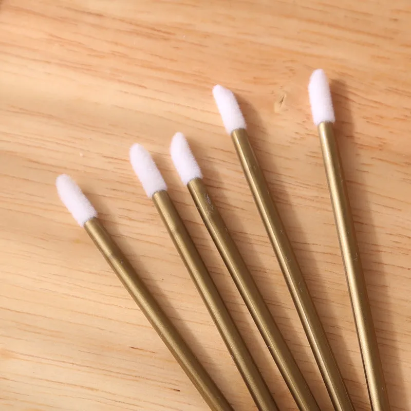 Pack of multi-coloured disposable lip brush applicators with flocked tips on a white background