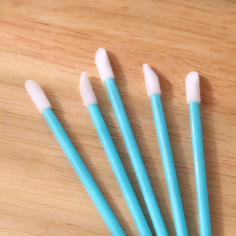 Pack of multi-coloured disposable lip brush applicators with flocked tips on a white background
