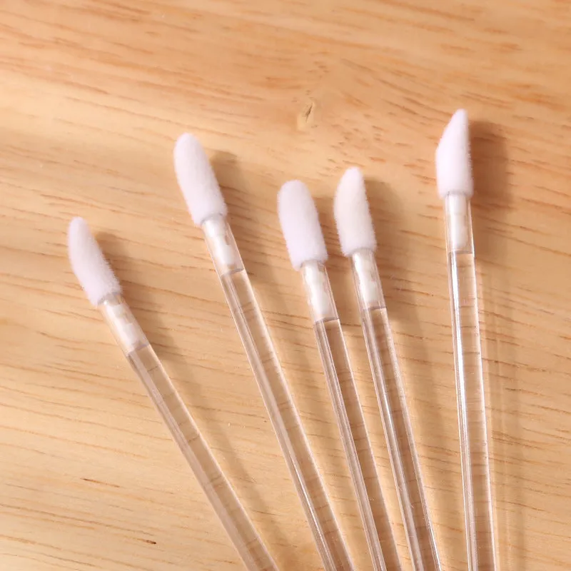 Pack of multi-coloured disposable lip brush applicators with flocked tips on a white background