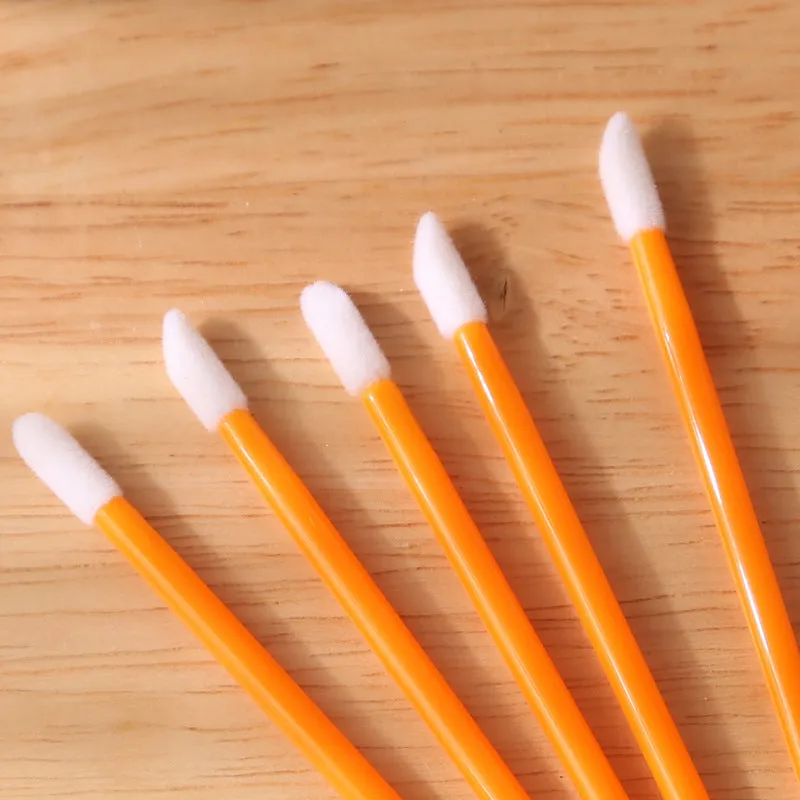 Pack of multi-coloured disposable lip brush applicators with flocked tips on a white background