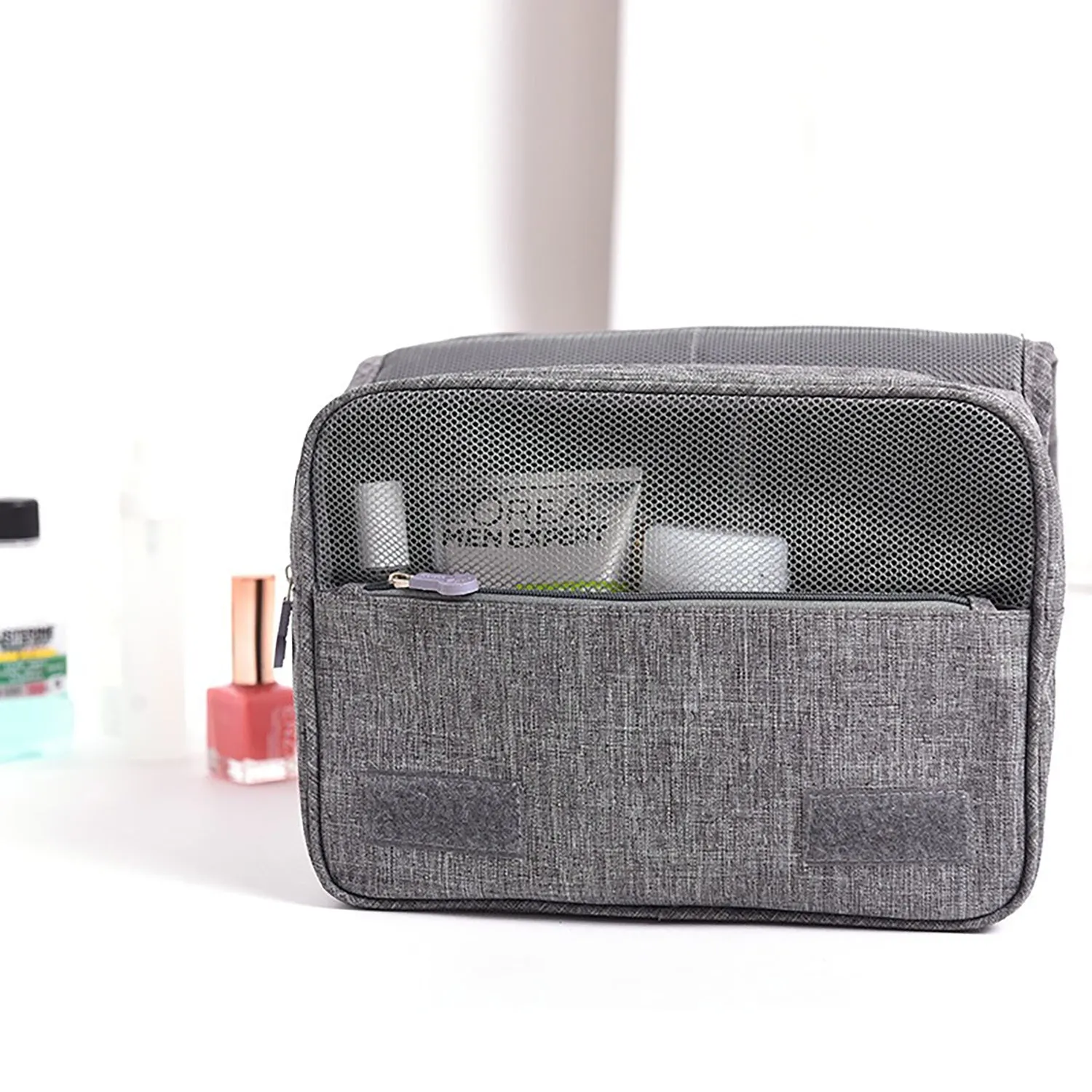 Large waterproof hanging toiletry bag in black with four compartments and metal hook