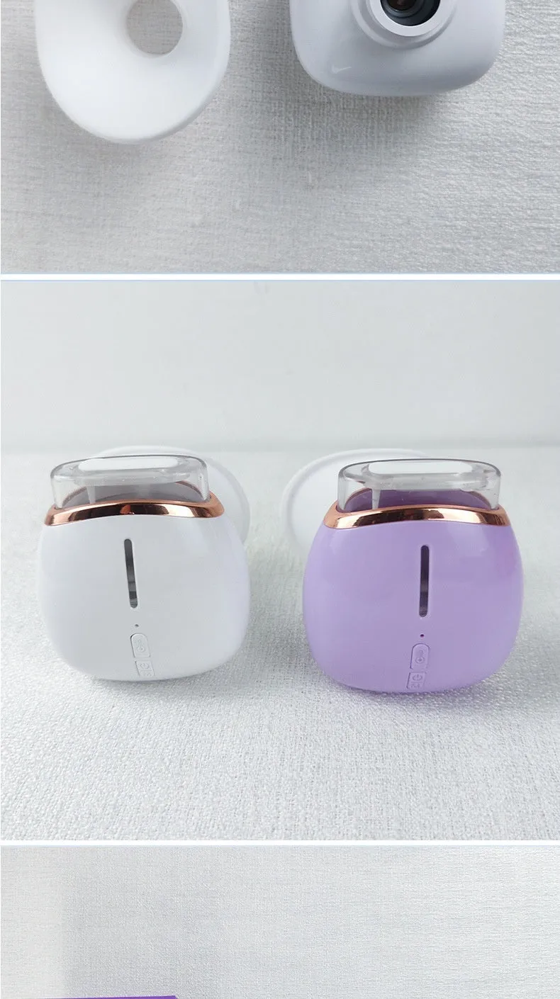 White and purple personal eye humidifier device with USB charging cable on a table.