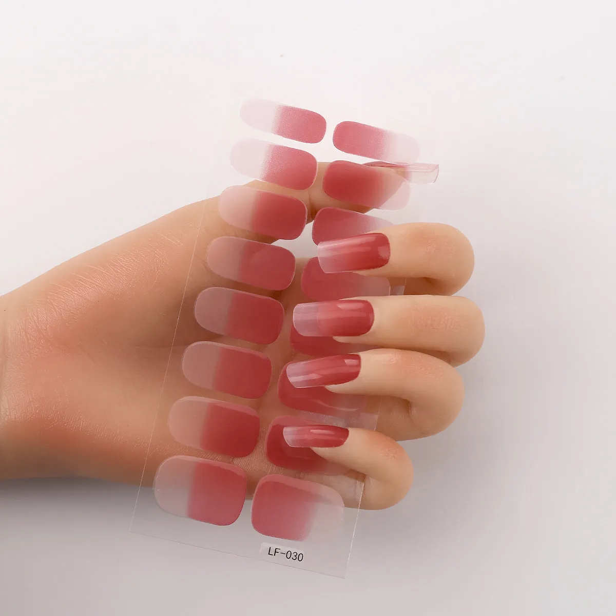 Pack of solid colour nail art stickers showing 16 different small designs including flowers, animals, and geometric patterns.