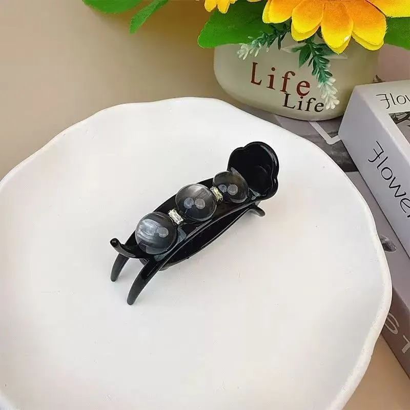 Acrylic pea barrette hair clip for women in green, shown against a dark background