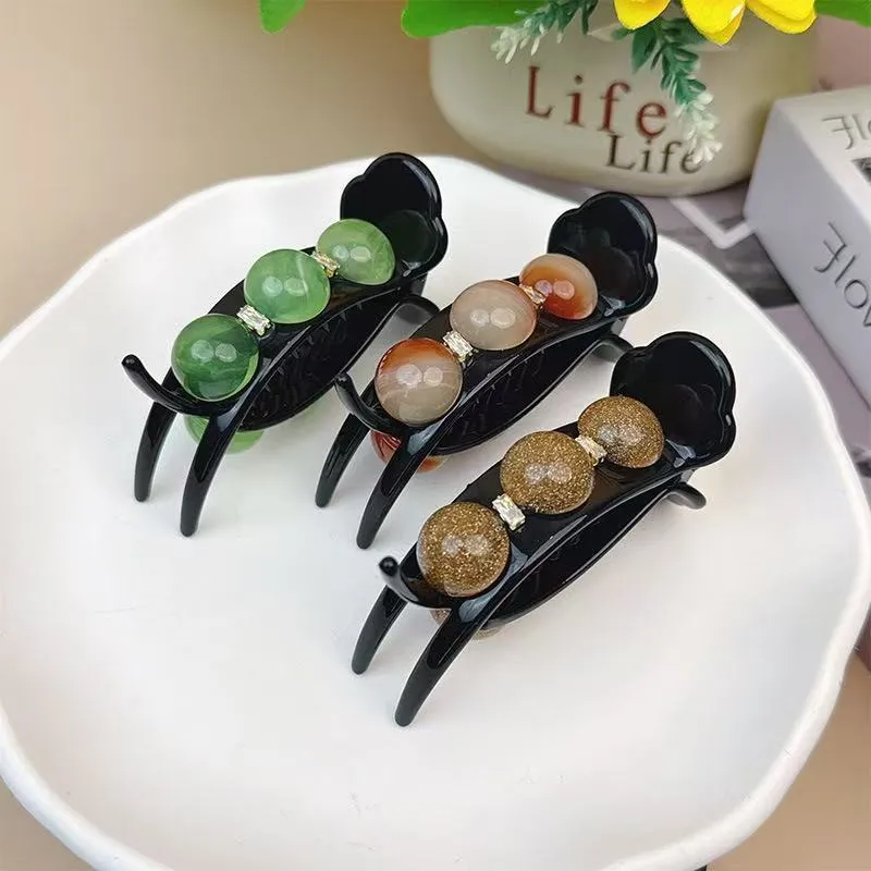 Acrylic pea barrette hair clip for women in green, shown against a dark background