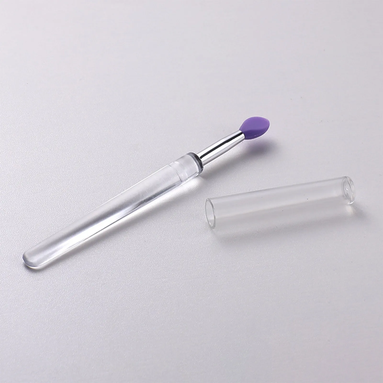 Set of four reusable silicone lip brushes with silicone caps in assorted colours