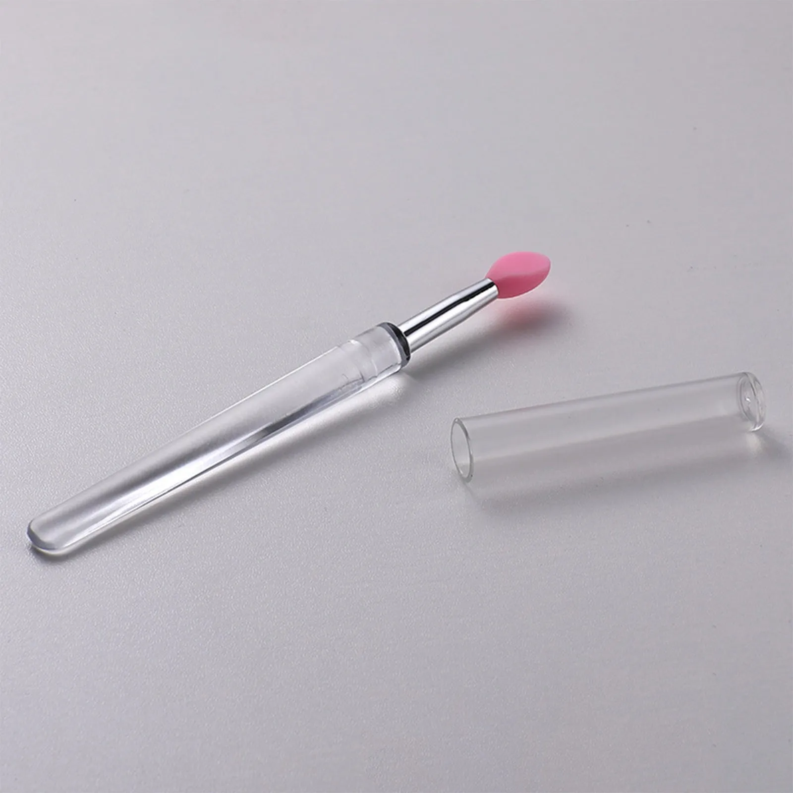 Set of four reusable silicone lip brushes with silicone caps in assorted colours