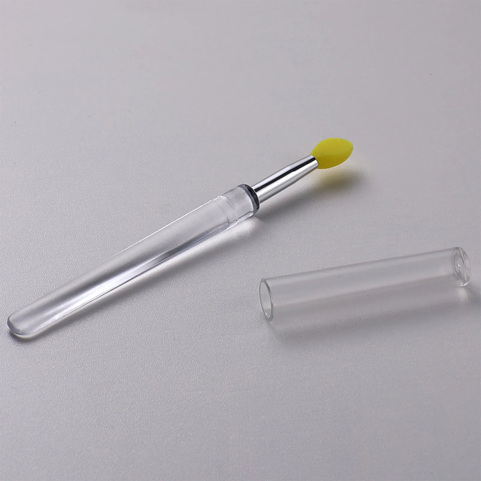 Set of four reusable silicone lip brushes with silicone caps in assorted colours