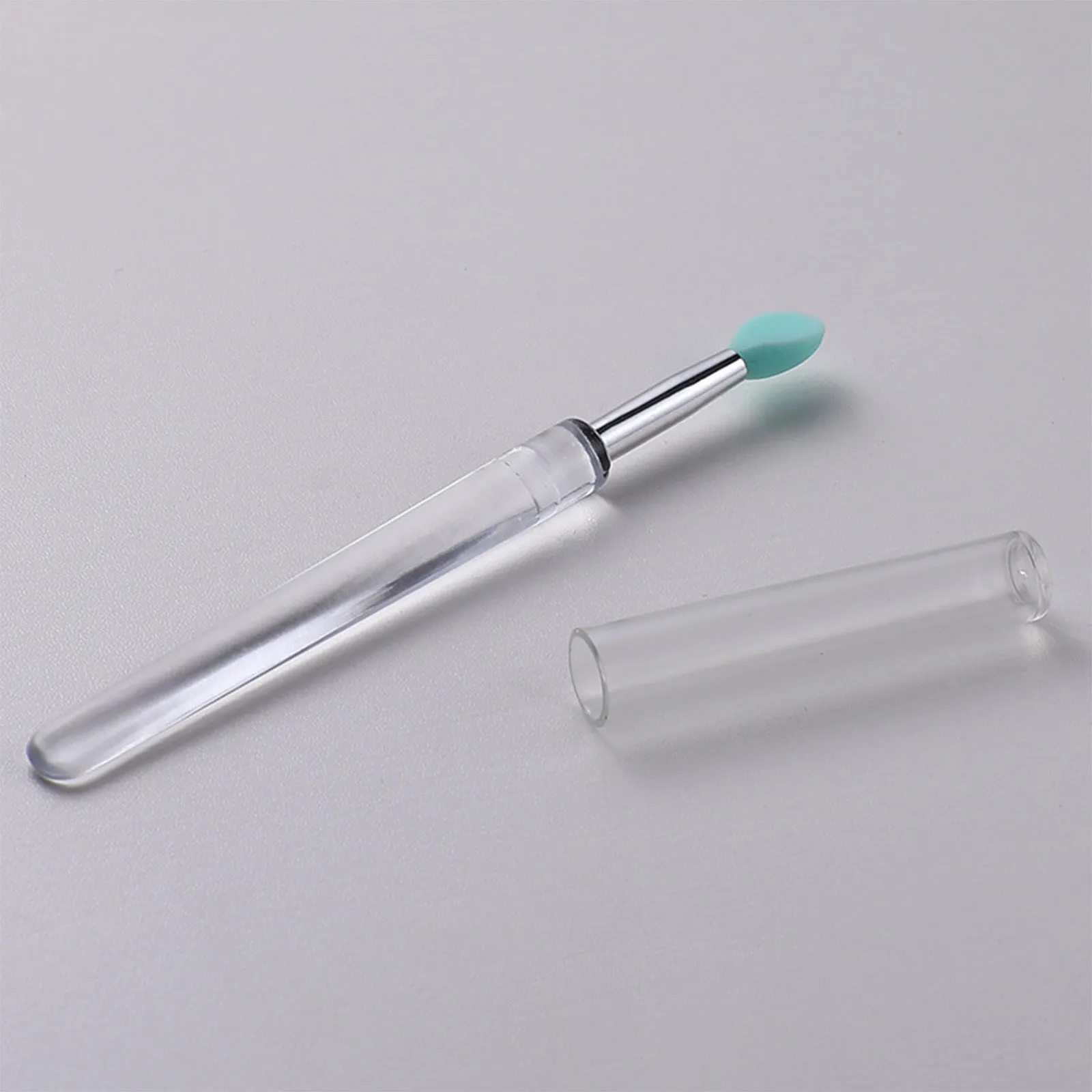 Set of four reusable silicone lip brushes with silicone caps in assorted colours