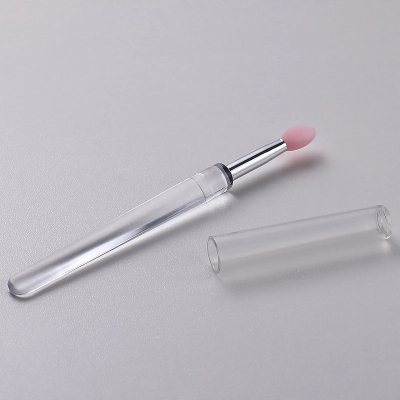 Set of four reusable silicone lip brushes with silicone caps in assorted colours
