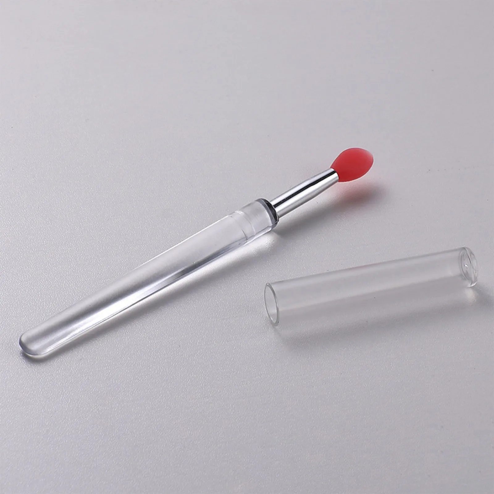 Set of four reusable silicone lip brushes with silicone caps in assorted colours