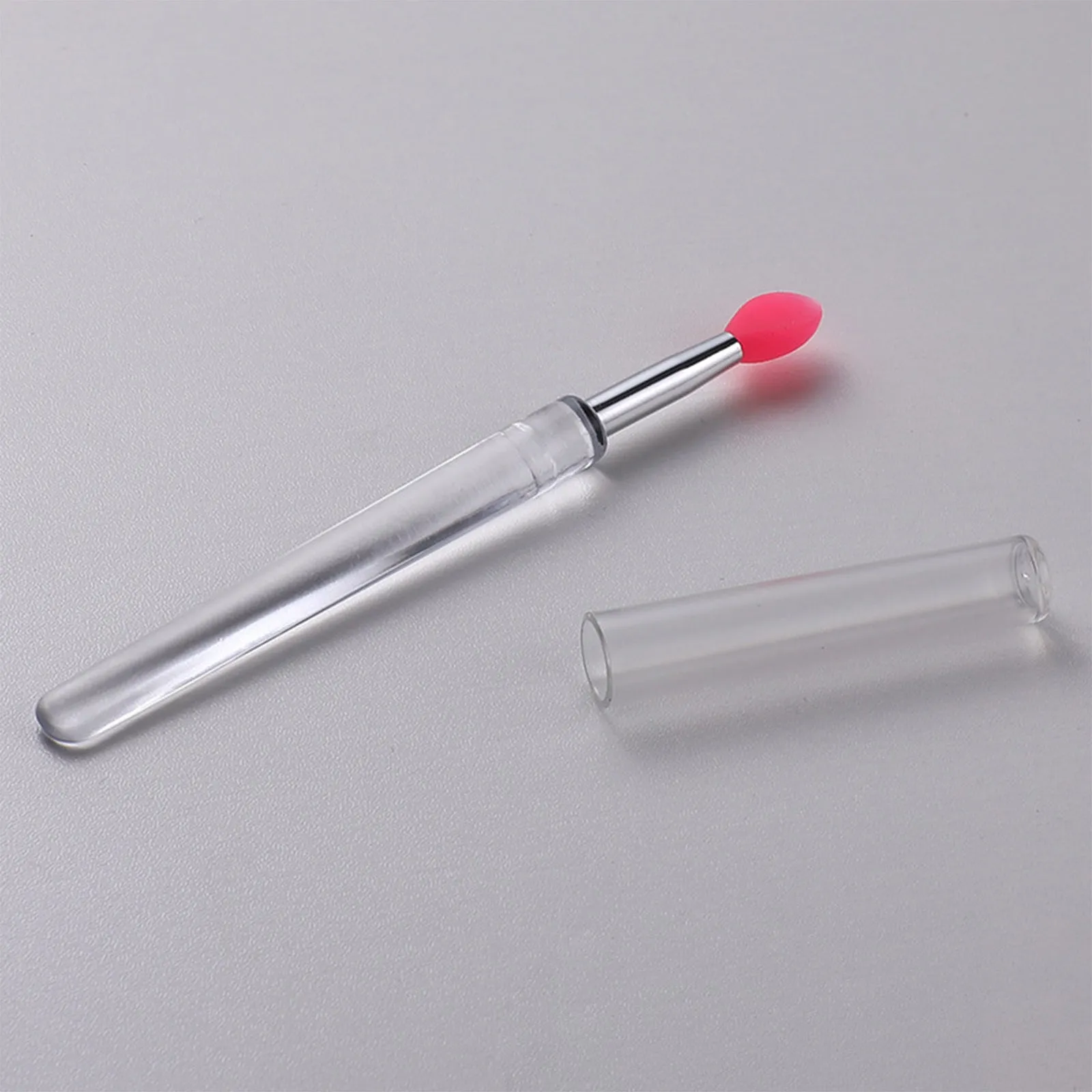 Set of four reusable silicone lip brushes with silicone caps in assorted colours