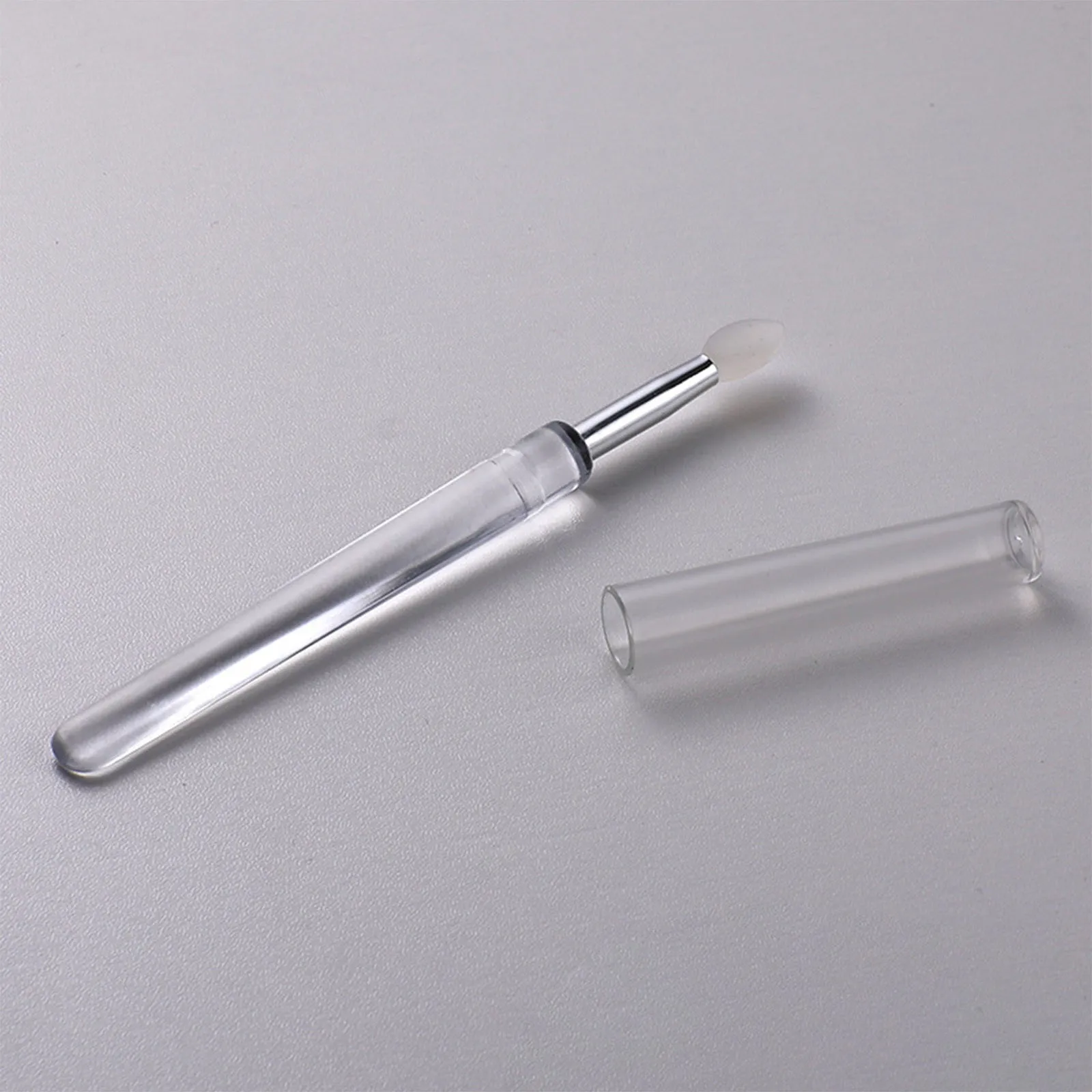 Set of four reusable silicone lip brushes with silicone caps in assorted colours