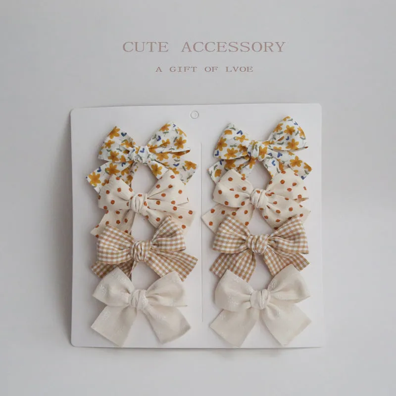 Dovetail bow hairclip set for children in cloth material with eight colour options