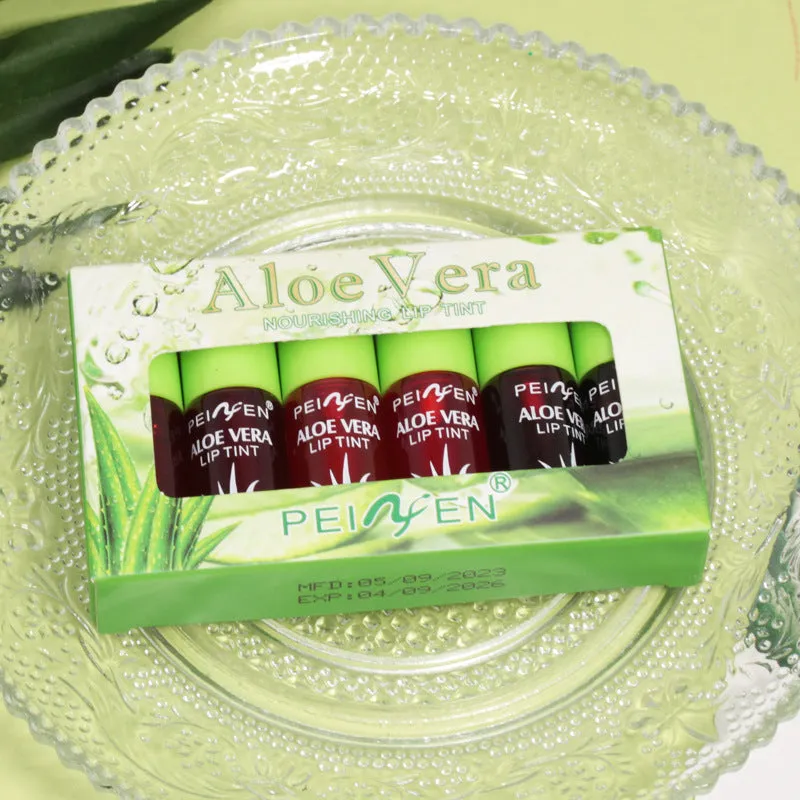 Set of six aloe lip gloss tubes in different colours on a light background