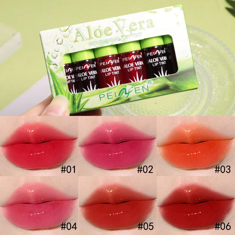 Set of six aloe lip gloss tubes in different colours on a light background