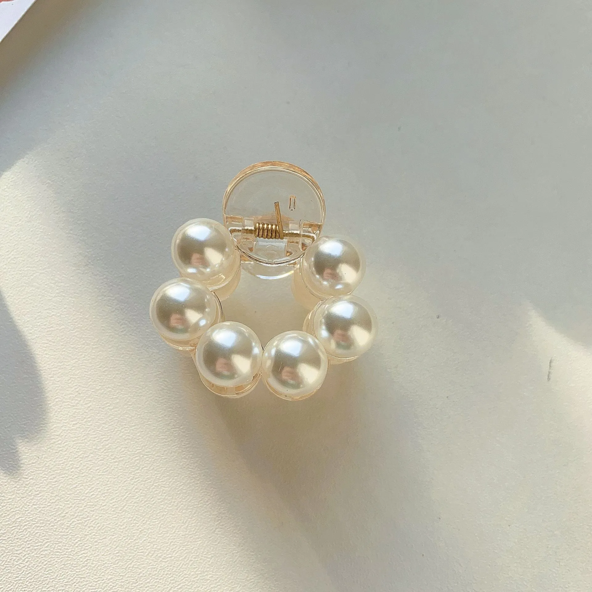 Women's pearl hair barrette in big pearl colour, manual finish, front view