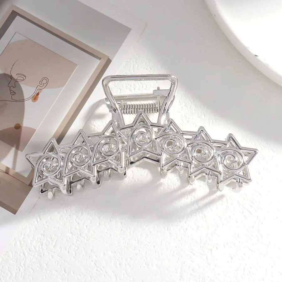 Assortment of silver metal hair barrettes and claw clips in various Korean-style designs on a white background.