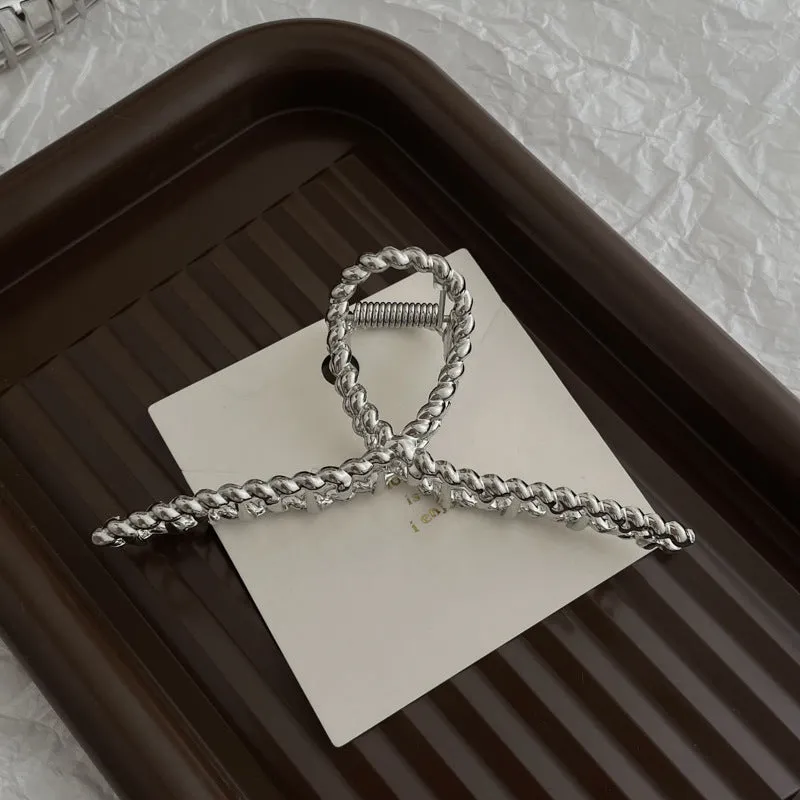 Assortment of silver metal hair barrettes and claw clips in various Korean-style designs on a white background.